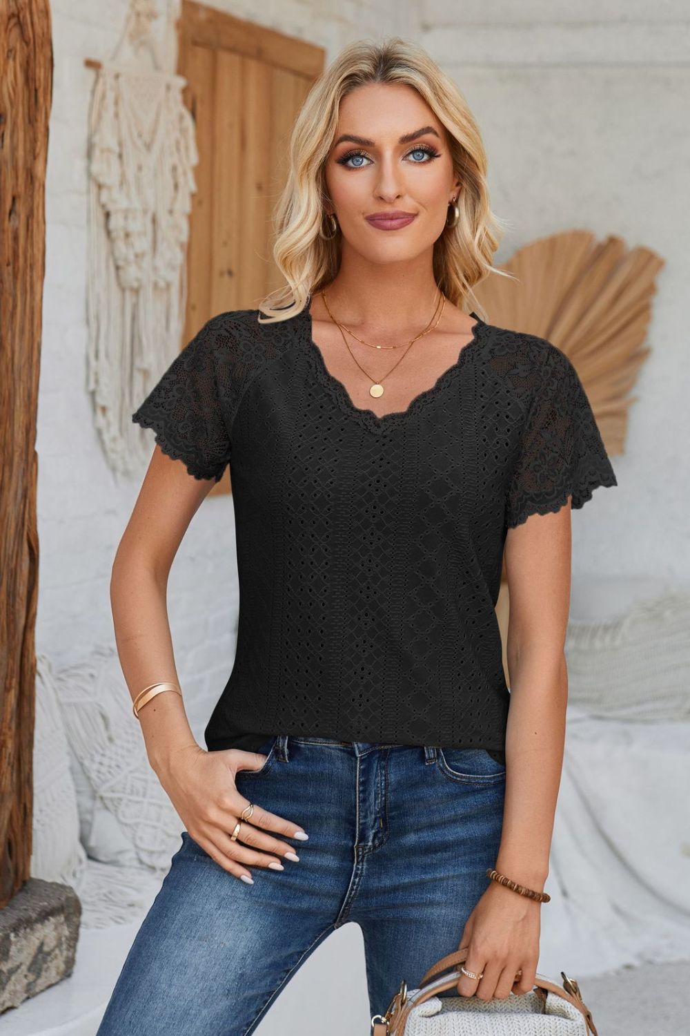 Black eyelet raglan blouse with lace short sleeves and scalloped neckline.