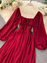 Red maternity dress with square neck, ruffled trim, tie detail, smocked bodice, and balloon sleeves.