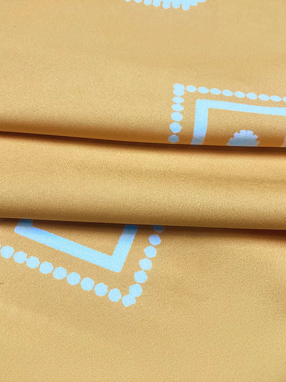 Geometric print midi dress in mustard yellow with light blue pattern detail.