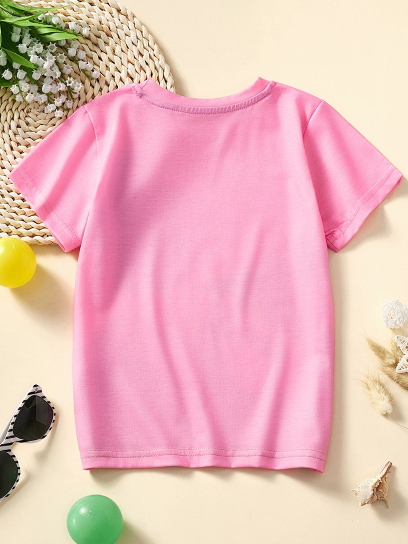Toddler pink graphic t-shirt with short sleeves and crew neck.