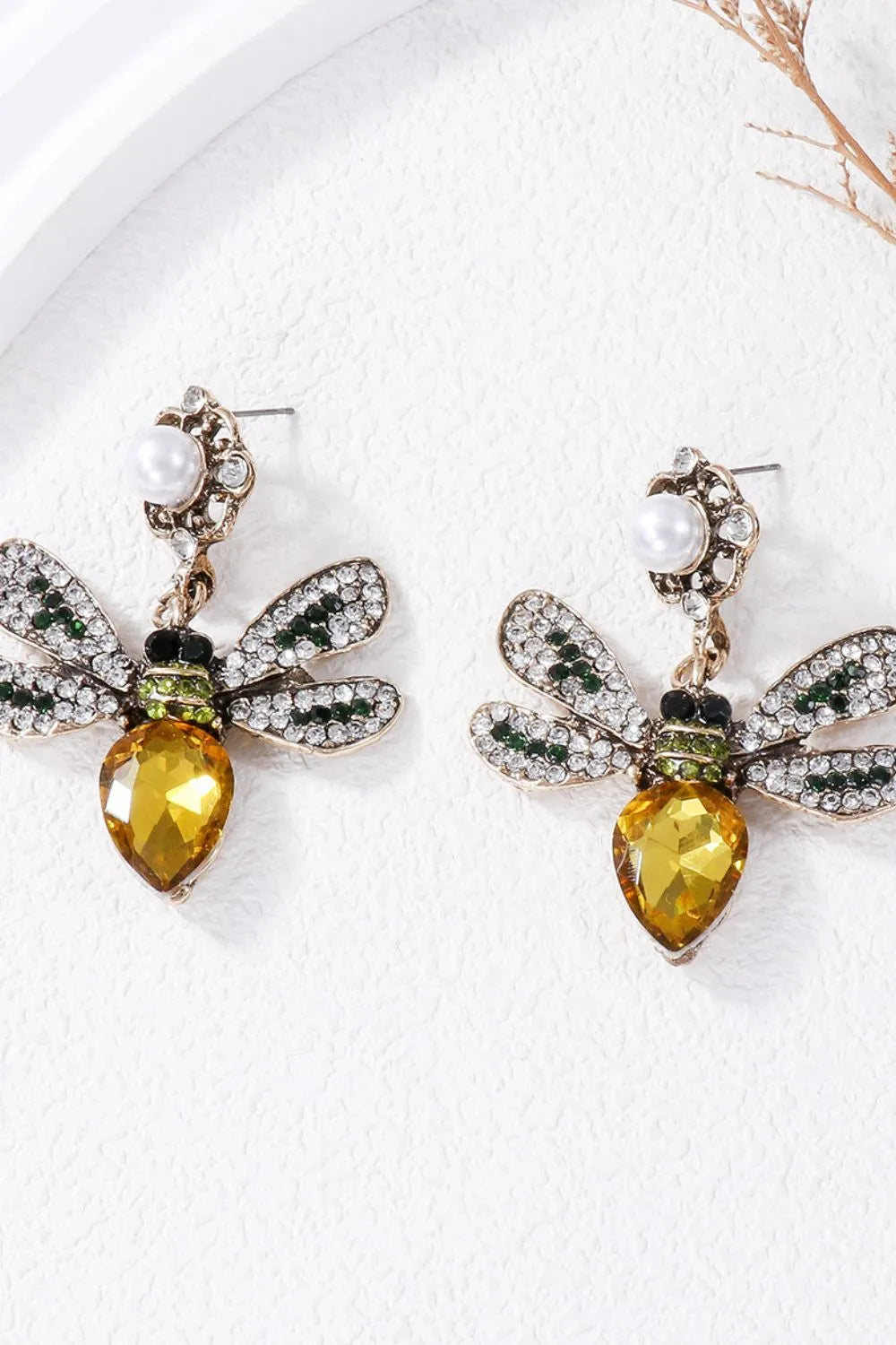 Jeweled dragonfly chandelier earrings with yellow gem body and crystal wings.