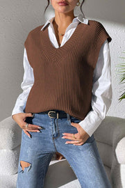 Textured knit V-neck sleeveless top in chocolate acrylic, styled with a white shirt and jeans.