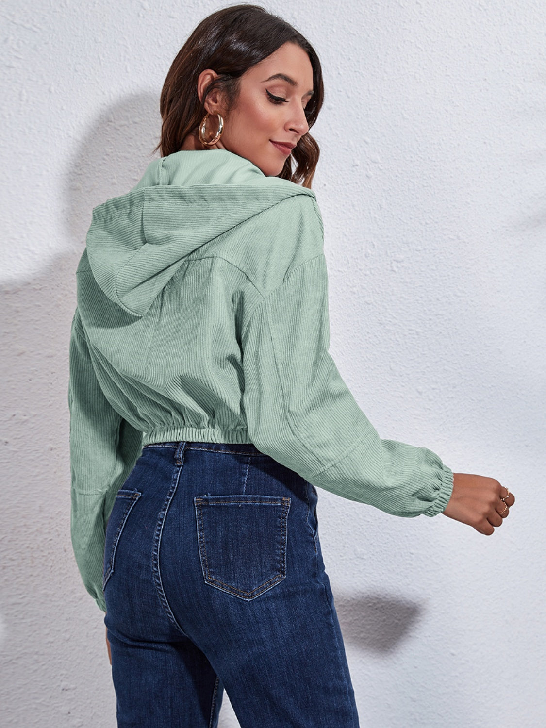 Light green corduroy hooded jacket with cinched waist and cuffs.