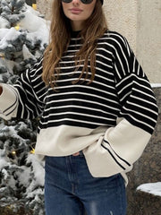 Colorblock stripe knit sweater with bell sleeves and cream hem.