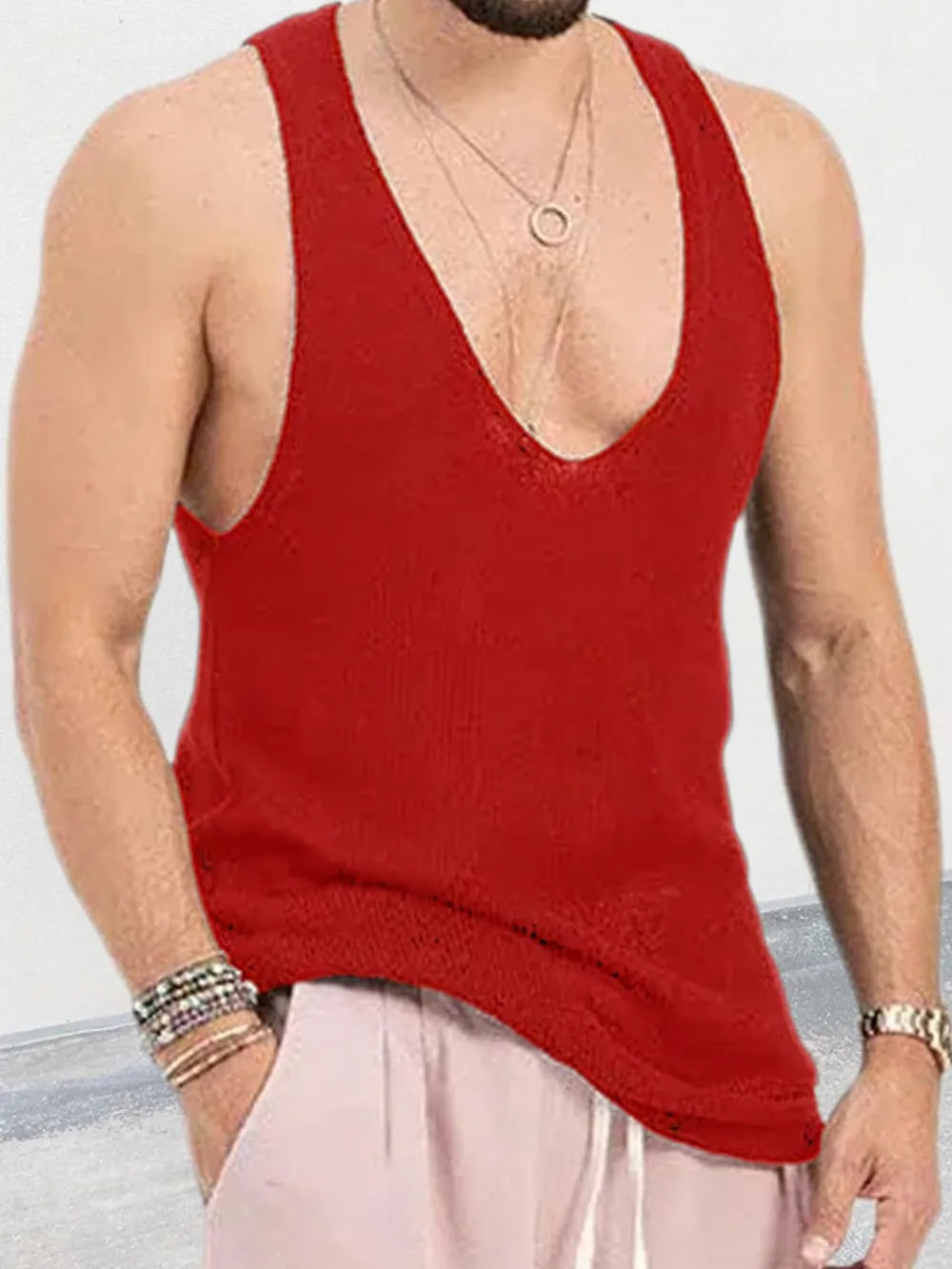 Deep red knit tank top with a deep V-neck, worn by a man.