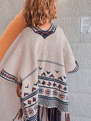 Apricot kimono with embroidered trim and fringe hem, featuring geometric patterns.