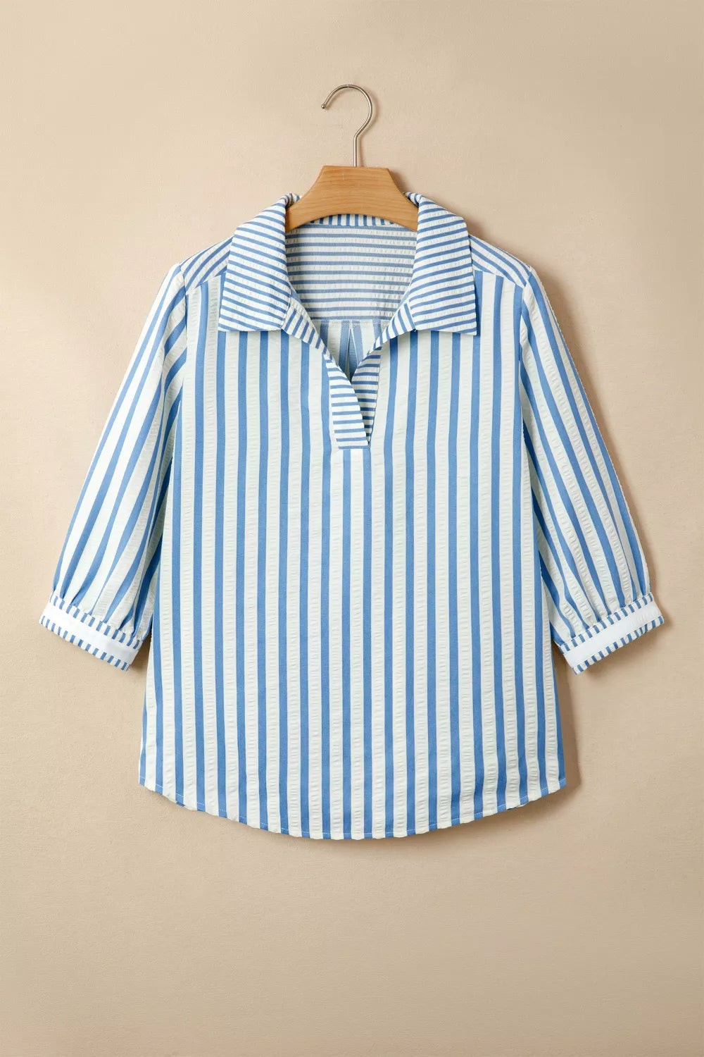 Blue and white striped collared blouse with textured fabric and 3/4 sleeves.