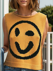 Mustard knit tank top with black smiley face graphic and crew neck.