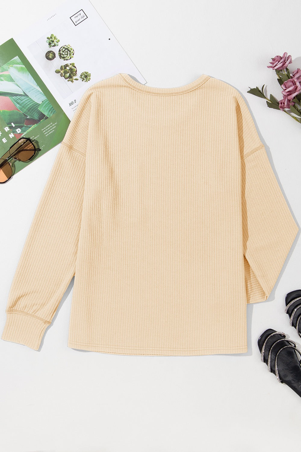 Tan ribbed knit long sleeve top with crew neck and relaxed fit.
