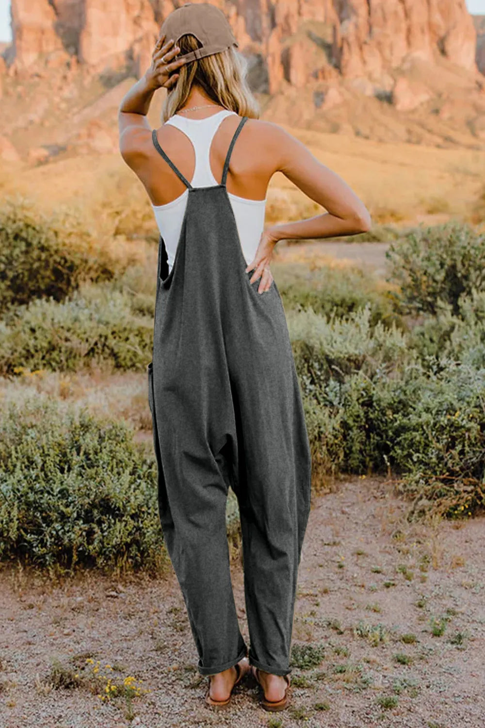 Gray cotton jumpsuit with wide legs and pockets, styled with a white tank top.