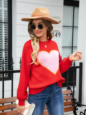 Red acrylic sweater with pink heart motif and balloon sleeves.