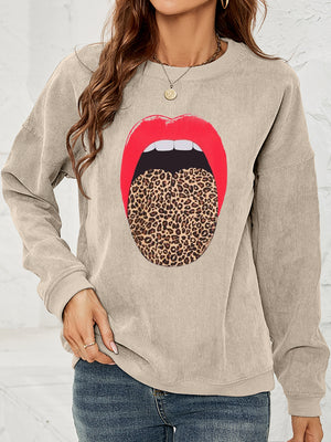 Tan corduroy crewneck sweatshirt with a bold red lip and leopard print tongue graphic.