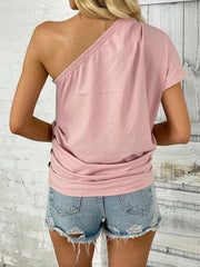 Blush pink asymmetric drape t-shirt with one shoulder and short sleeves.