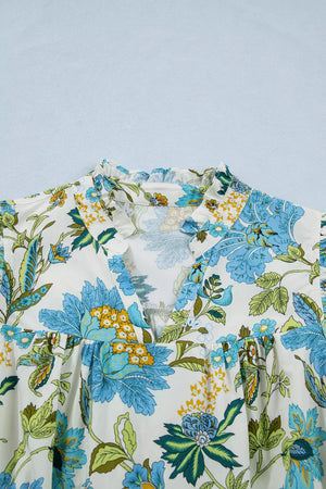 Floral V-neck mini dress with ruffled sleeves and a colorful floral print on cotton fabric.