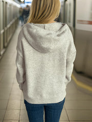 Gray knit hoodie with textured star appliqué detail on shoulders.