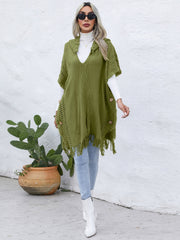Matcha green knit poncho with fringe and wooden buttons, V-neck, hooded, open sides.