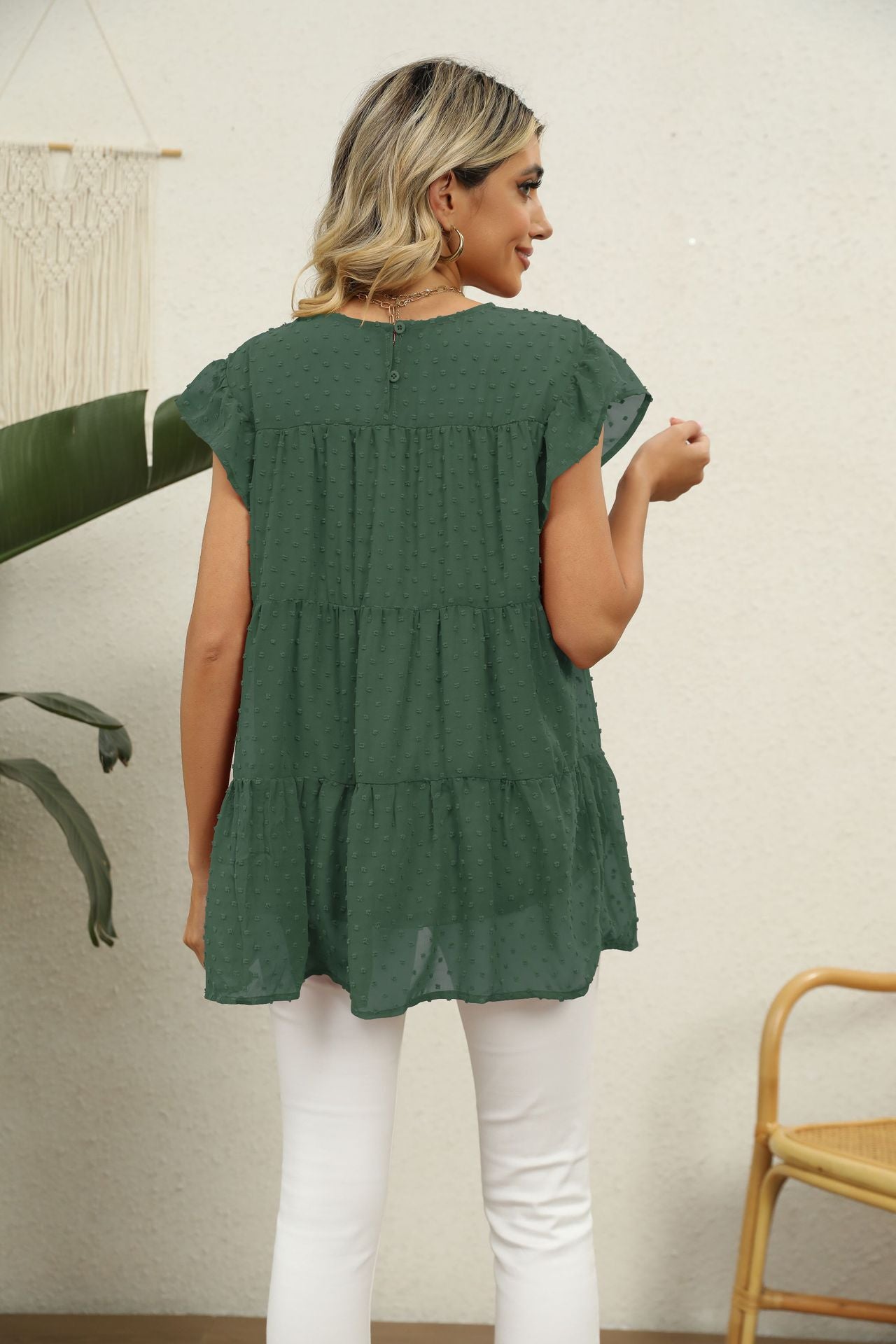 Forest green Swiss dot tiered blouse with flutter sleeves and button back detail.