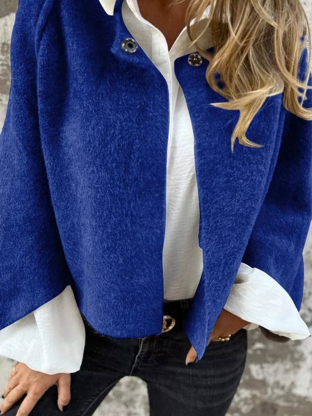 Blue fuzzy knit cardigan with button detail, worn open over a white shirt.
