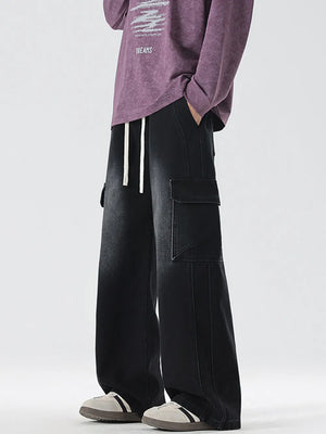 Black oversized cargo jeans with drawstring waist and large side pockets.
