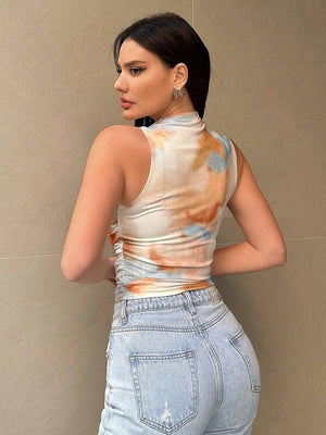 Sleeveless mock neck top with tie-dye pattern in white, orange, and blue, featuring ruched sides.