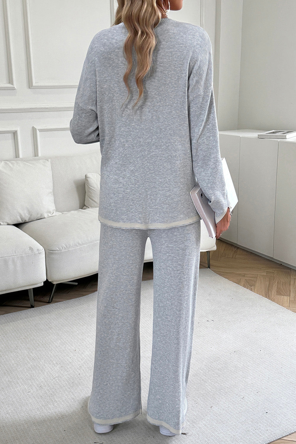 Light gray ribbed knit lounge set with cream trim, featuring a relaxed fit sweater and wide-leg pants.