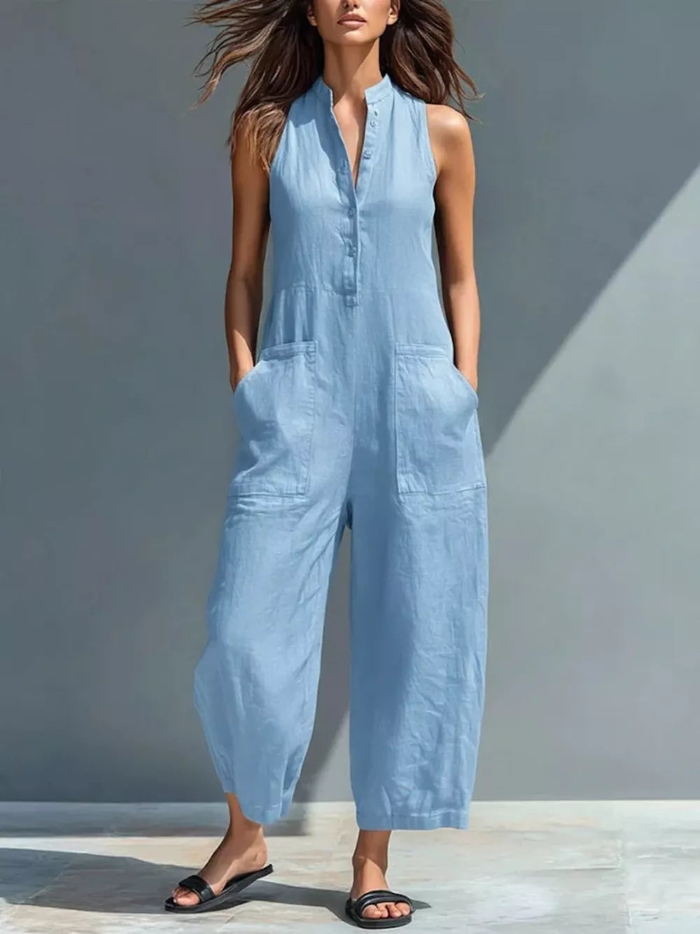 Sky blue sleeveless button-down romper with pockets and wide legs