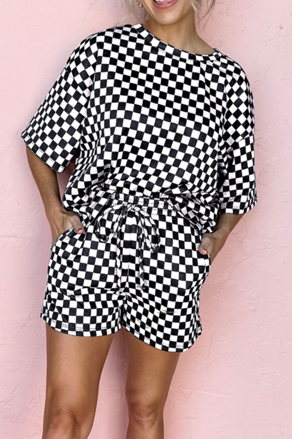 Black checkered loungewear set with short sleeves and drawstring shorts.
