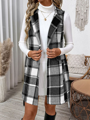 Plaid longline vest in dark gray with a belted waist and notched lapels, worn over a white turtleneck dress.