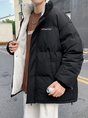 Black oversized quilted puffer jacket with sherpa lining and embroidered detail.