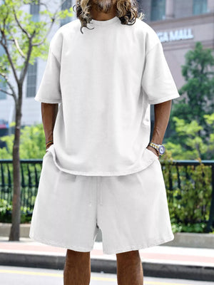 Men's white relaxed fit two-piece set with drawstring shorts and short sleeve t-shirt.