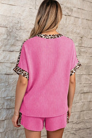 Ribbed pink pajama set with leopard trim on crew neck and short sleeves.