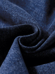 Patch pocket wide-leg jeans in medium wash denim, showing fabric texture.