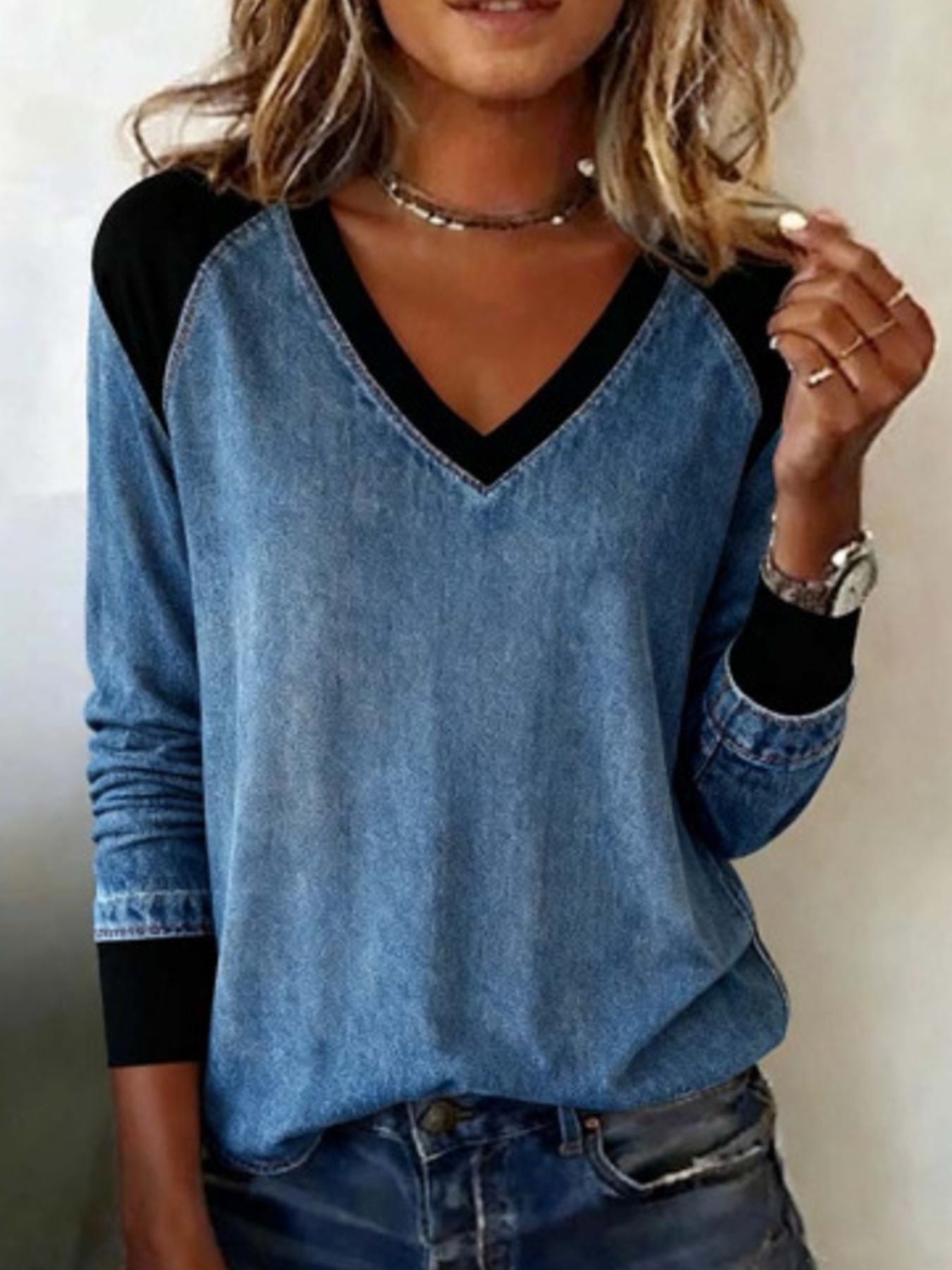 Patchwork V-neck long-sleeve blouse with black accents and banded cuffs.