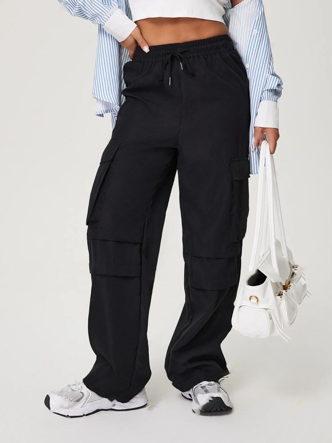 Black utility cargo pants with wide legs and multiple pockets.
