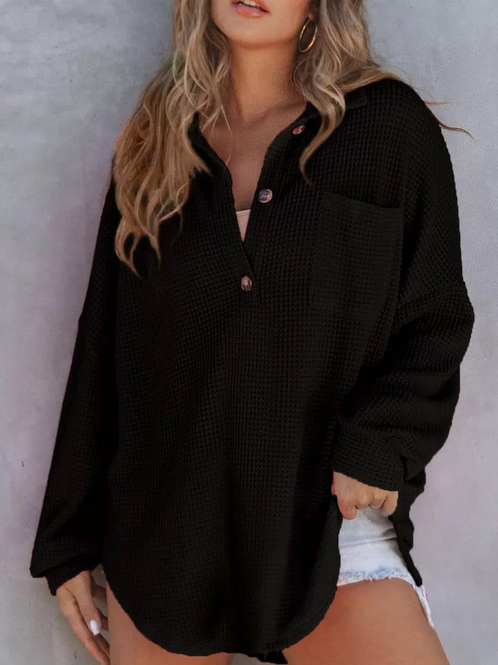 Black waffle-knit henley tee with button front and chest pocket.