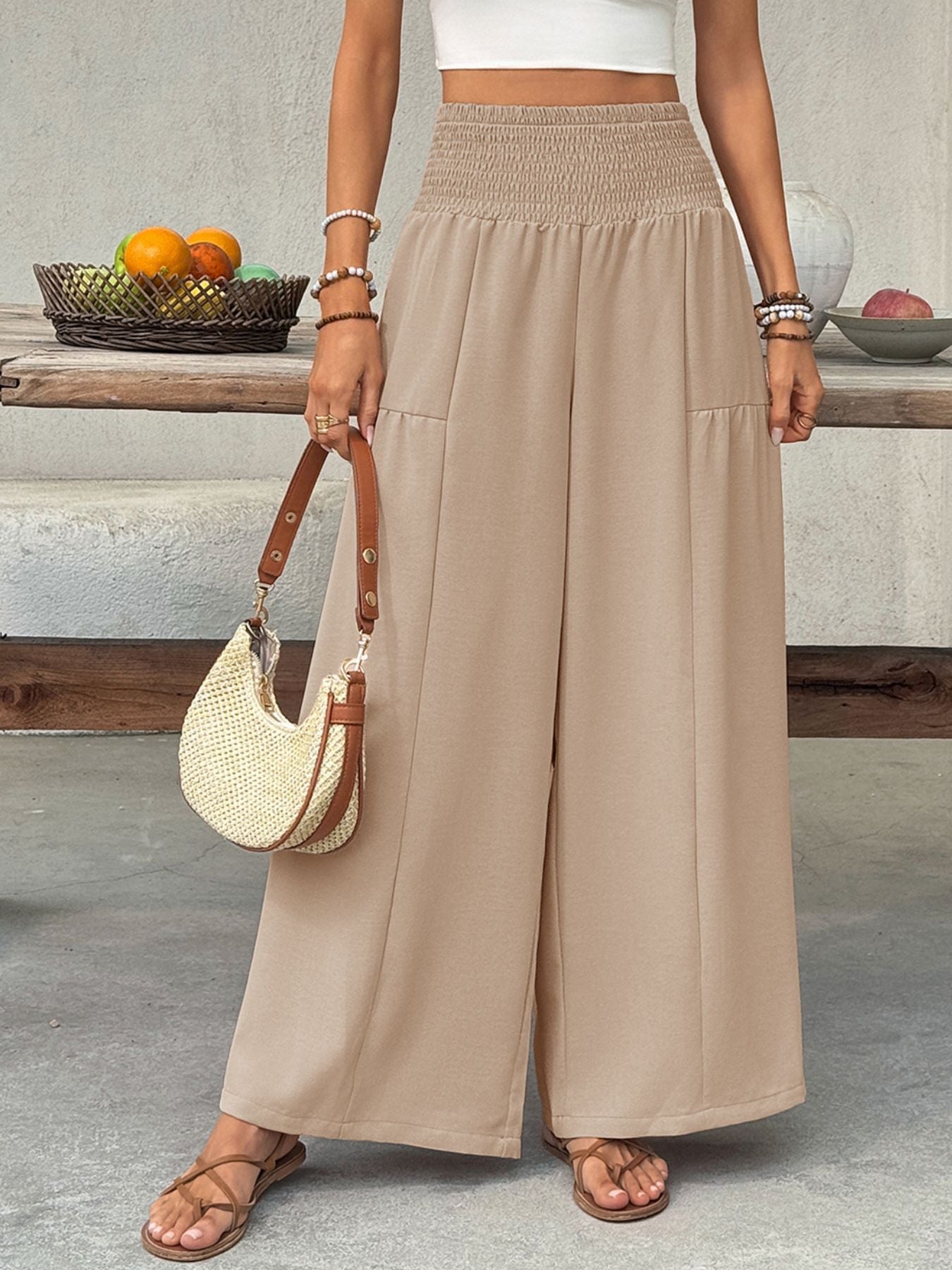 Smocked waist wide leg cotton pants in beige with front pockets.