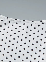 White t-shirt with black polka dots and a ruched detail at the neckline.