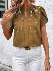 Embroidered floral keyhole blouse in rust with short flutter sleeves and a v-neckline.
