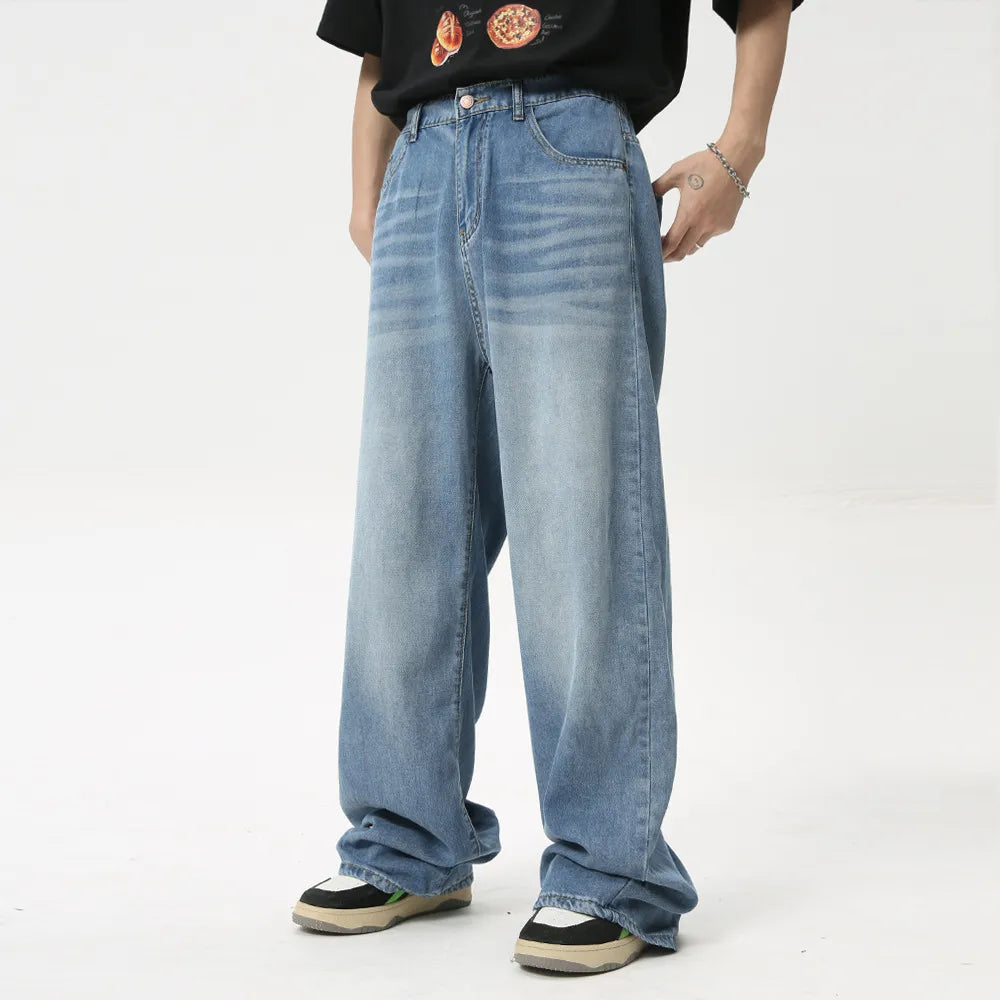 Oversized baggy denim trousers in medium wash, featuring a relaxed fit and casual style.