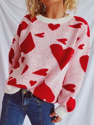 Heart motif knit sweater in pink with red hearts, crewneck, long sleeves, casual style.