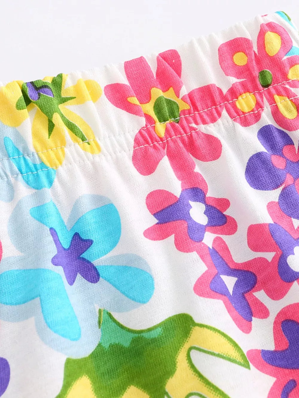 Toddler cotton one-piece with a colorful floral print and elastic waistband.