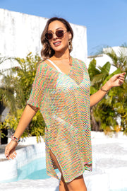 Rainbow crochet tunic cover-up with V-neck, short sleeves, and side slits.