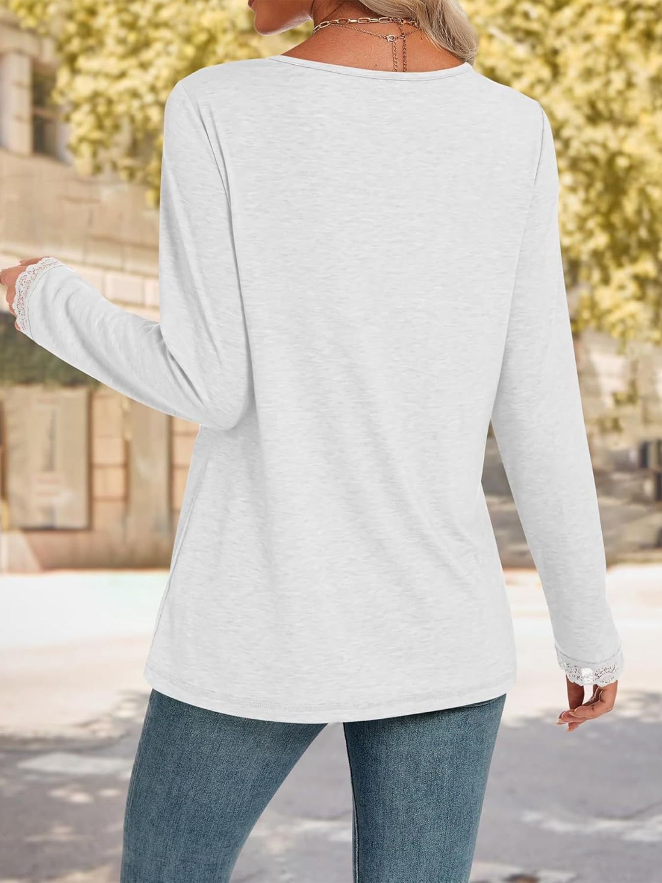 White long sleeve t-shirt with lace trim on the cuffs.