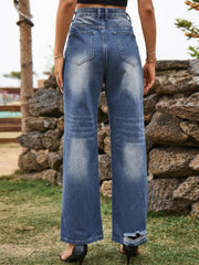 Distressed blue denim flare jeans with frayed hem detail.