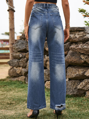 Distressed blue denim flare jeans with frayed hem detail.