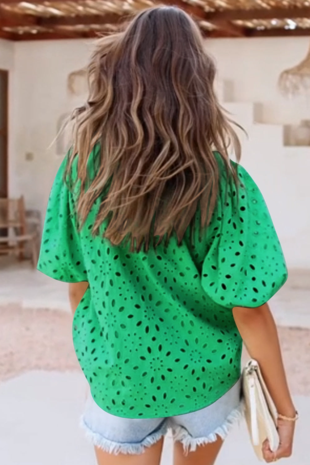 Green eyelet puff-sleeve blouse with a floral cut-out pattern.