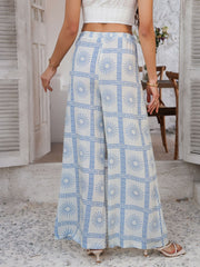 Light blue and white geometric print wide-leg drawstring trousers with a sunburst pattern.