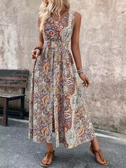 Vibrant paisley print maxi dress with cinched waist and dramatic slit.