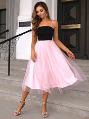 Pink tulle skirt midi dress with black bodice and spaghetti straps.
