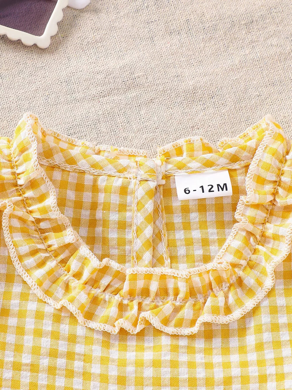 Light yellow gingham baby set with ruffled collar and size tag